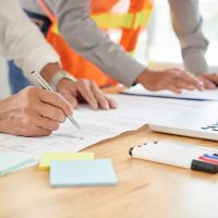 Close-up image of engineer making marks on blueprint